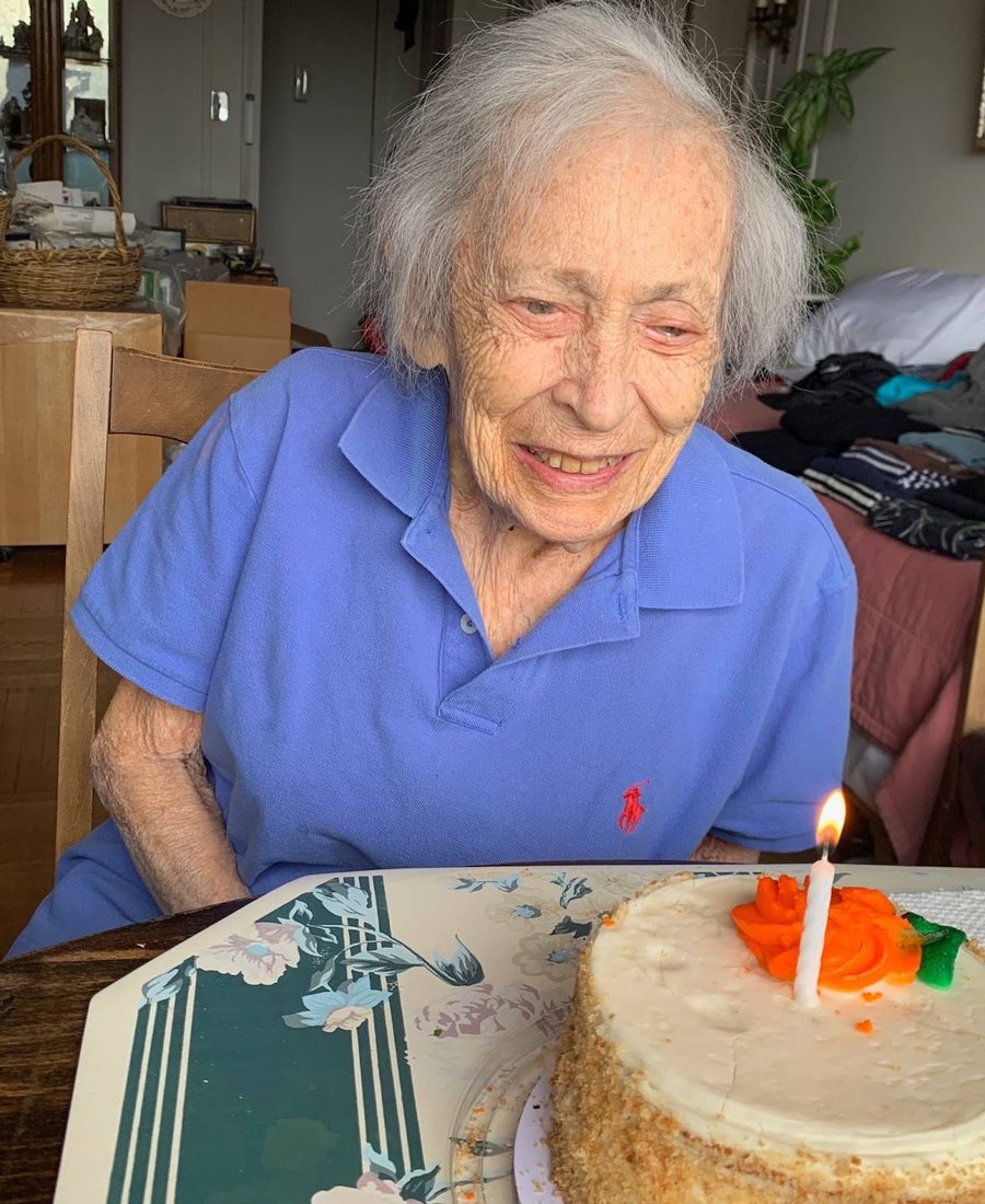 Alice Wimpfheimer smiling beside a birthday cake with a single candle. Read her story.